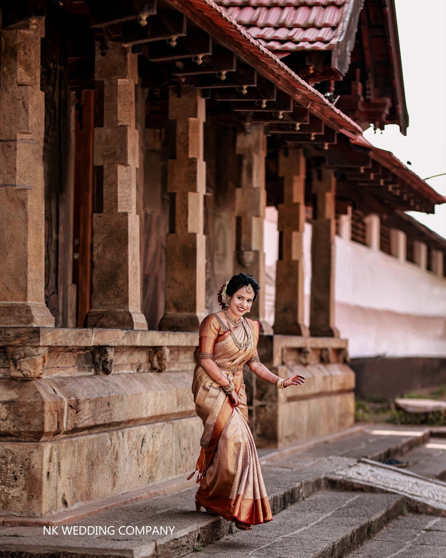 Bride in traditional attire outside a heritage home